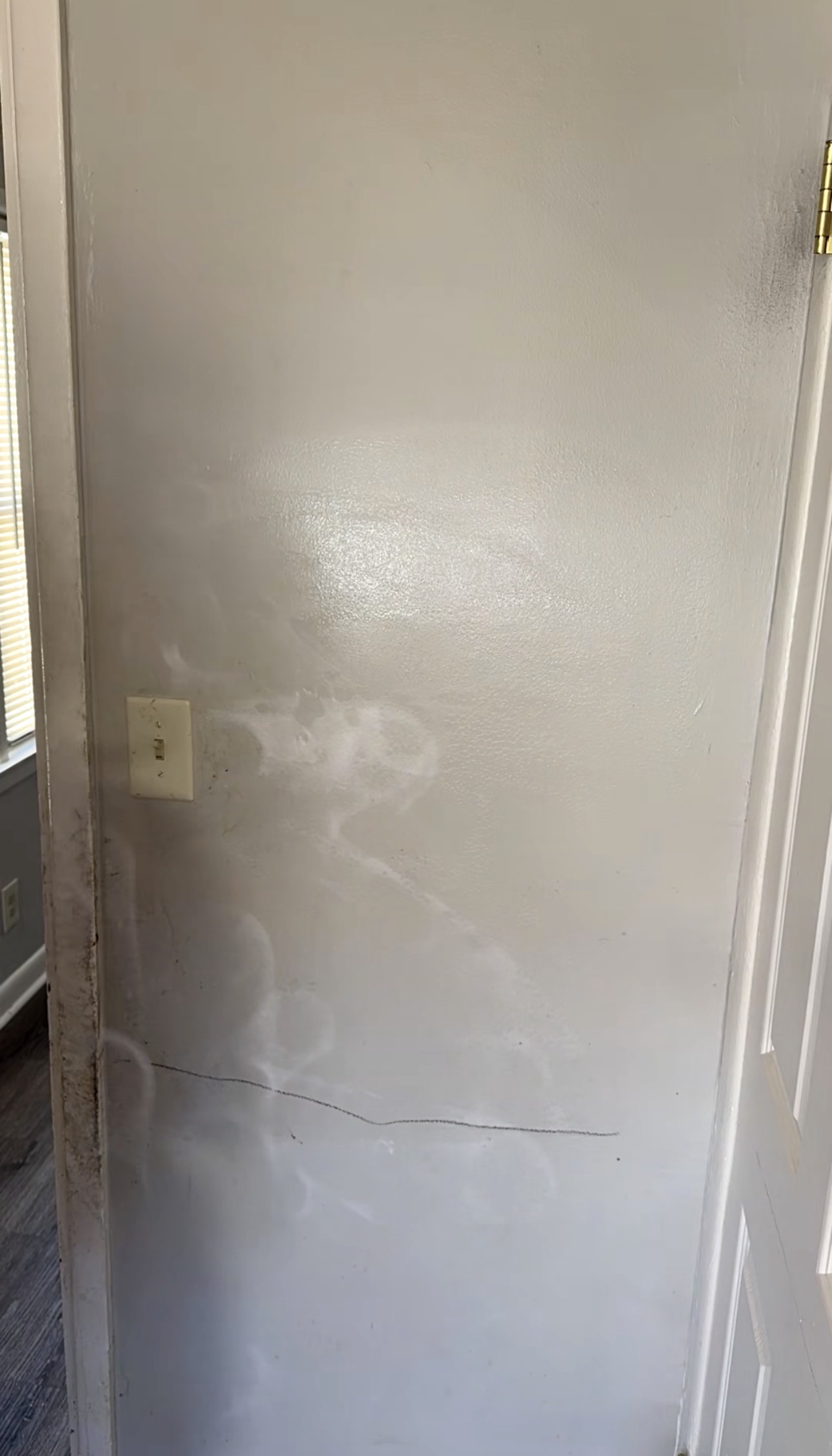 Wall before cleaning - stains smudges and buildup visible